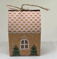 a brown box with trees on it and a window in the front is tied to a string