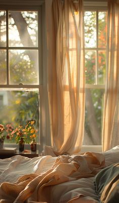 the sun is shining through the window in the room with the comforter and pillows