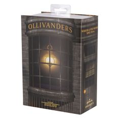 an open box with a light on the window in front of it that says, ollivanders