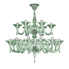 a green chandelier hanging from the ceiling with several lights on each one side