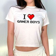 I Love Gamer Boys 90s Baby Tee, Aesthetic Tee, Women's Fitted Tee, Unisex Shirt, Trendy Top, Y2K 90s Baby Tee, Gift For Her, Gift For Friend DETAILS - 100% cotton (fiber content may vary for different colors) - tear-away label  SIZING Sizes vary by shirt style. Please check the size chart before making your purchase. PLEASE NOTE: Our Baby tee is sized for a youth, reminiscent of the '90s-era shrunken-down T-shirt. This style, popularized by the skater/raver culture of the time, is not to be conf 90s Inspired Cotton Tops With Funny Print, 90s Style Cotton Tops With Letter Print, Retro Crew Neck Top With Heart Graphic, 90s Inspired Short Sleeve Tops With Funny Print, 90s White Slogan Tops, 90s Style White Slogan Tops, 90s Inspired Short Sleeve Top With Text Print, Retro Summer Tops With Heart Graphic, Y2k Cotton Tops With Heart Graphic