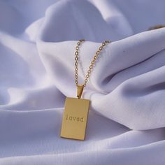 You are so very loved. This is a perfect reminder to yourself and a great gift for someone you love! 18K Gold Plated Stainless Steel 16.25" with 2.5" Extender 20mm Pendant Jewelry Care: It is important to gently clean your jewelry with a soft cloth after each use. We recommend removing your jewelry when bathing or before applying oils, lotions, and perfumes for optimal longevity. Inspirational Gold Necklaces For Valentine's Day, Inspirational Gold Necklace For Valentine's Day, Meaningful Rectangular Necklaces For Gifts, Meaningful Rectangular Necklace For Gift, Meaningful Gift Necklace, Inspirational Hypoallergenic Necklace For Gifts, Inspirational Gold Necklaces For Gifts, Inspirational Gold Necklace, Inspirational Rectangular Jewelry For Gifts