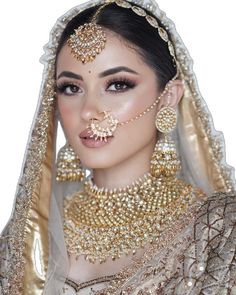 a woman in a bridal outfit with jewelry on her face