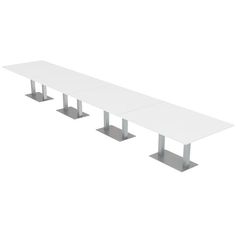 a long white table with four silver pedestals on each side and one end missing