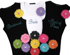 the bride and groom shirts are decorated with flowers