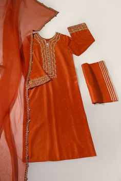 A beautiful festive look in the captivating shade of burnt orange, crafted on pure raw silk in a long kameez silhouette, heavily embellished with gold zardozi craftsmanship, each stitch is a testament to generations of artistry. Completing this masterpiece of a design is a fully embellished soft pure organza dupatta, a Long Kameez, Punjabi Suits Party Wear, Festive Look, Organza Dupatta, Punjabi Suits, Party Wear Dresses, Bridal Designs, Pakistani Fashion, Formal Wedding