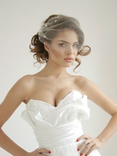 a woman in a wedding dress with her hands on her hips