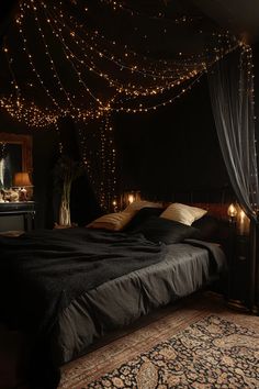 a bedroom with lights strung from the ceiling and a large bed in front of it