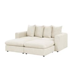 a white sectional couch with pillows on it's back and the seat facing outward