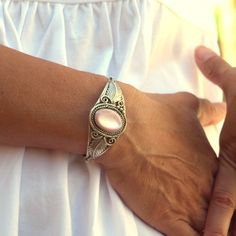 This is a beautiful vintage sterling silver and light pink mother of pearl open cuff Native American style bracelet. It is marked Sterling L. Spencer .925. The bracelet has an excellently looking construction. The pink mother of pearl is oval shaped and is about 3/4" tall by about 5/8" wide. The leaves, filigree and overall design make it beautiful and strong. The serrated bezel ring around the stone is tall enough to hold the stone solidly.   This  bracelet is in great pre-owned vintage condition It is built as a small to medium. The opening is about 1 1/8" wide where you slip you wrist through and the inside diameter is about 2 1/4" at its widest points.   This is a very nice gift or get it for yourself. More jewelry in my shop https://www.etsy.com/shop/AGardenCottage?ref=seller-platform Bohemian Style Oyster Bracelet, Bohemian Stamped 925 Bracelet Gift, Elegant Adjustable Pink Sterling Silver Bracelet, Bohemian Nickel-free Cuff Bracelet For Wedding, Nickel-free Bohemian Cuff Bracelet For Wedding, Bohemian Sterling Silver Bracelet As Gift, Vintage Sterling Silver Bracelet Stamped 925, Bohemian Pink Cuff Bracelet As Gift, Silver 925 Stamped Cuff Bracelet As A Gift