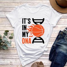 a t - shirt that says it's in my dna with an image of a basketball