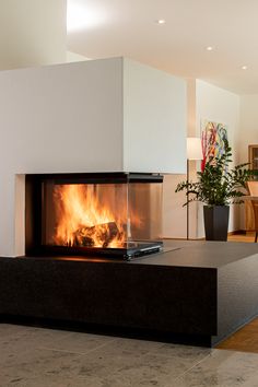 a modern fireplace in the middle of a living room