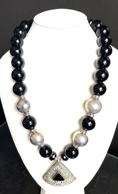 "Big, bold, elegant, dramatic statement necklace Gorgeous rich black onyx beads Afghan Kuchi nomadic medallion pendant of silver and onyx (2.25\"x2.25\") Silver round and filigree beads Silver spacers and toggle clasp Length: 26\" #359 - \"Black Mamba\"" Black Medallion With Large Pendant, Formal Black Jewelry With Large Beads, Luxury Black Necklace With Polished Beads, Black Round Jewelry With Large Beads, Silver Onyx Necklace With Black Beads, Black Onyx Jewelry With Silver Beads, Modern Black Round Beads Necklace, Modern Black Necklace With Round Beads, Black Jewelry With Large Beads