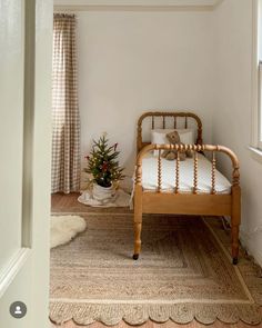 a bed sitting in a bedroom next to a window