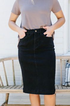 Our new and improved take on the classic 'Leah' Denim Skirt in Black! Modesty. Comfort. Style. This denim midi skirt has it all... stretch, cotton fabric and a timeless button-fly closure! We love that the simple lines of the 'Leah' skirt add a touch of class to any outfit. Designed by us with you in mind, we think you are going to fall in love with this skirt as much as we did! 97% Cotton 3% Spandex Machine Wash Cold Tumble Dry Low or Hang to Dry Do Not Bleach Low Iron if Needed Do Not Dry Clea Knee Length Denim Skirt Outfit, Apostolic Fashion Casual, Modest Skirt Outfits, Denim Pencil Skirt Outfit, Denim Skirt Knee Length, Black Skirt Outfits, Modest Skirt, Black Jean Skirt