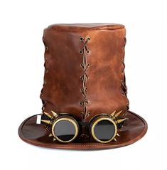 Make a bold statement this halloween with this stylish brown faux leather top hat with steampunk googles. This eye-catching hat is perfect for costume parties, adding a touch of elegance to your look. The faux leather material is soft and comfortable to wear, making it ideal for all-night celebrations. The steampunk googles add a unique, vintage element to your costume. Get yours today and make a stylish statement this halloween! * material: faux leather * color: brown * pattern: solid * decoration: glasses with rivets * top type: flat * great hat for halloween or cosplay parties Gentleman Hat, Leather Top Hat, Steampunk Top, High Hat, Steampunk Top Hat, Steampunk Hat, Magic Hat, Leather Weaving, Sorel Winter Boot