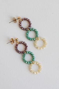 The finishing touch to all your best looks is the Melissa Teal Beaded Circle Drop Earrings! These trendy gold earrings start with a stud post back and fall to colorful beaded circles. Add these fun earrings to a floral dress + sandals to add a girly touch to your look! Gold Plated Beaded Circles Stud Post Back One Size | Length 2” Trendy Gold Earrings, Beaded Circle, Diy Jewelry Making Tutorials, Fall Bead, Homemade Earrings, Beaded Earrings Diy, Beachglass Jewelry, Handmade Jewelry Tutorials, Fall Earrings