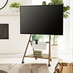 a flat screen tv sitting on top of a wooden stand