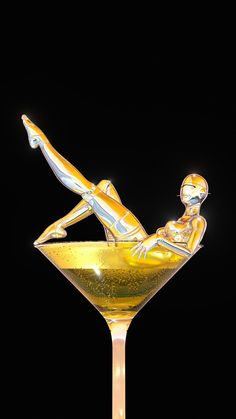 a martini glass with an image of a woman laying on the rim in front of a black background