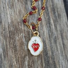 "Sacred Heart Gold Pendant Charm. Beautiful and super cute pendant-charm made in 18k gold, not plated, not filled. This piece is solid, not hollow. Use it in a necklace with lots of charms, alone or in a bracelet. This is truly a piece you can pass down to your younger generations as a keepsake. SIZE Tall: 0.72\" / 18.4mm (aprox. including bail) Wide: 0.34\" / 8.8mm (in the widest part) Come follow us on Instagram as @orommajewelry and @shinyhappylily to see many more amazing pieces and to get d Dangling Charms For Valentine's Day Gift, 14k Gold Pendant Charm Necklace For Valentine's Day, Valentine's Day Gift Charms With Dangling Details, Heart-shaped Charm Necklace With Dangling Charms For Gift, Heart-shaped Charm Necklaces For Gifts, Dangling Pendant Charms For Valentine's Day, Valentine's Day Pendant Charms With Dangling Details, Valentine's Day Dangling Charms Pendant, Valentine's Day Pendant Charm Gift