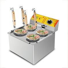 four pizzas are being cooked in a deep fryer