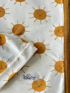 an orange and white blanket with yellow sun print