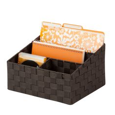 a brown basket with some folders inside of it