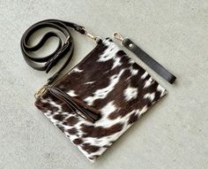 Western Cowhide Leather Crossbody Bag Purse Handbag Clutch Wristlet Dark Brown | Cowgirl Gifts This stunning crossbody purse is made of high-quality cowhide leather in a rich, dark brown color. The bag features a playful cow print pattern and is accented with tassels for a touch of western style.  Size: 10 inch x 8 inch  Detachable crossbody and wrist strap 6 credit card slots, 1 zip pocket, zipper closure Other colors available: Black and White: https://www.etsy.com/listing/717356296/ Light Brown/Tan: https://www.etsy.com/listing/711876589/ Cow Print Pattern, Cowgirl Gifts, Dark Brown Color, Cow Print, Printed Leather, Crossbody Purse, Western Style, Print Pattern, Wrist Strap