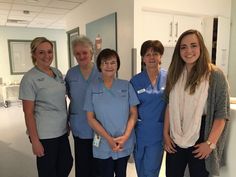 four women in scrubs are posing for the camera while standing next to each other