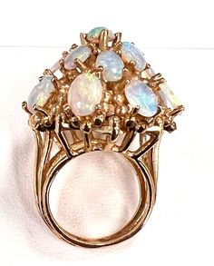 Add a touch of royalty to your jewelry collection with this Vintage Estate 14K Yellow Gold Opal "Princess Ring". The tiered cluster design showcases 17 natural opal gemstones that shimmer with vibrant, fiery colors. Sizable by your jeweler, this unbranded ring is perfect for those who crave unique, one-of-a-kind pieces. #VintageJewelry #OpalRing #GoldJewelry #ClusterRing #UniquePiece 🌟💍👑 Collectible 14k Gold Multi-stone Rings, Collectible Multi-stone 14k Gold Rings, 14k Gold Fine Jewelry With Stone Setting, Luxury Yellow Gold Cluster Ring, Collectible Cluster Fine Jewelry, 14k Gold Opal Ring Collectible Fine Jewelry, Gold Multi-stone Cluster Ring Collectible, Fine Jewelry Multi-stone Collectible Rings, Collectible Yellow Gold Opal Ring