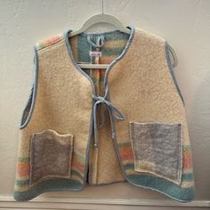 Rarely Used Item Has Been Worn A Few Times, But Still In Excellent Condition. Blanket Vest Hand Made By Olive Rose Studio In Montreal 100% Recycled Wool Blanket Cozy And Cropped A-Line Shape Layering Piece Made Of Thick Wool For Under Coats Or Over Sweaters Two Front Pockets And Bow At Front Fabric / Material 100% Recycled Wool Blanket Thick Wool Felt Vest, Handmade Vest, Blanket Cozy, Thick Wool, Wool Blanket, Cozy Blankets, Layering Pieces, Womens Vest, Wool Felt