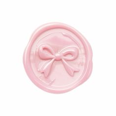 a pink wax stamp with a bow on it