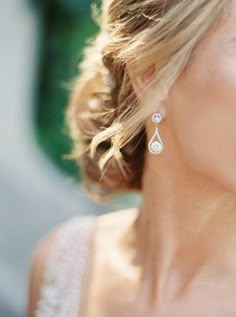 a close up of a woman wearing earrings