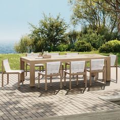 an outdoor table and chairs on a deck