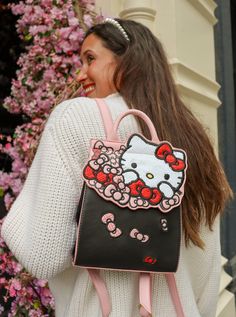 Bow obsessed and always looking your best! The Hello Kitty Bow Backpack keeps you stylish on the go. Featuring a sleek black base with contrasting pink edge paint. The front flap showcases Hello Kitty herself in a white sequin fabric, and a bouquet of bows in plaids, shimmer, and weave fabrics. Keep all your essentials at hand by using the interior pocket, and adventure with ease using the adjustable straps. Made of faux/vegan black and pink leather with an interior Hello Kitty bow polyester lin Bow Bouquet, Hello Kitty Handbags, Hello Kitty Bow, Danielle Nicole, Hello Kitty Pink, Girly Bags, Bow Pattern, Hello Kitty Items, Pink Backpack