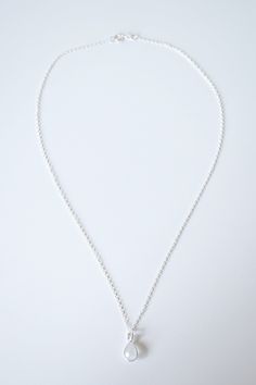 "Perfect for minimalist styling. A dainty moonstone teardrop gemstone is encircled by a sterling silver frame, and suspended on a silver necklace chain. *Free shipping for orders to USA and Canada, and no duties and customs fees.* > Comes beautifully packaged and ready for gift giving > 18\" necklace chain shown in product photo, and is our most popular necklace length > Looks lovely layered with other necklaces > Matching earrings available > Gold necklace version available in th Silver Teardrop Charm Necklace With Delicate Chain, Nickel Free Teardrop Sterling Silver Charm Necklace, Everyday Teardrop Sterling Silver Charm Necklaces, Sterling Silver Teardrop Charm Necklace With Delicate Chain, Everyday Sterling Silver Teardrop Charm Necklaces, Nickel-free Teardrop Charm Necklace In Sterling Silver, Nickel-free Teardrop Sterling Silver Charm Necklace, Delicate Teardrop Sterling Silver Charm Necklace, Everyday Sterling Silver Teardrop Charm Necklace