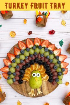 a turkey fruit tray with grapes and strawberries