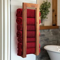 red towels are hanging on a towel rack in the bathroom