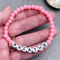 BREATHE Acrylic Bead Bracelet - the perfect mix of style and motivation, this bracelet features a simple yet inspiring design to remind you to take a moment to breathe. Available in a variety of colors, choose the one that speaks to you. The custom made bracelet has 6mm acrylic beads and flat white acrylic letter beads, which are 7mm diameter. It is thread on strong elastic and will stretch a little bit so you can roll it onto your wrist gently. Allergy friendly, lightweight and super comfortabl Inspirational Beaded Bracelets For Everyday, Inspirational Hypoallergenic Stretch Bracelet For Everyday, Inspirational Hypoallergenic Stretch Bracelet With Round Beads, Inspirational Stretch Bracelet With 8mm Round Beads, Inspirational 8mm Beads Stretch Bracelet, Casual Healing Friendship Bracelets With 8mm Beads, Casual Hypoallergenic Beaded Bracelet For Everyday, Take A Moment To Breathe, Acrylic Letters