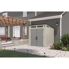 an outdoor storage shed is shown in front of a house with a pergolated roof