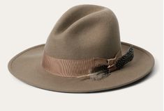 This striking, stylish fedora is made in the USA of 100% firm wool felt. It features a 4 1/2” teardrop crown and a 4” bound-edge flat brim. Additional details include a five-chain link hat band, a silver-toned arrow pin and a cloth sweatband for breathability and comfort. 4" Bound Edge Flat Brim 4 1/2" Teardrop Crown 5 Chain Link Hat Band Silver Arrow Pin Cloth Sweatband 100% Firm Wool Felt Made in the USA HOW TO DETERMINE YOUR HAT SIZE Start with a measuring tape (or a piece of string you can m Formal Western Hat For Spring, Elegant Flat Brim Hat Band For Country Events, Western Style Formal Spring Hat, Formal Western Spring Hat, Spring Formal Western Hat, Elegant Brimmed Fedora For Country Events, Elegant Brown Fedora For Country Events, Western Style Fur Felt Fedora For Spring, Western Fur Felt Fedora For Spring