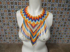 Handmade Huichol beaded collar statement bib necklace with dangle drop beads tribal boho hippie beach jewelry festival summer fun adjustable This beautiful collar bib necklace is adjustable at the back of the glass yellow beads Fun Funky Festival Hippie Beaded Choker Necklace For Festivals, Large Beads Festival Choker, Festival Large Beads Choker, Hippie Beaded Choker Necklace, Adjustable Boho Collar Necklace For Festivals, Unique Beaded Festival Choker Necklace, Unique Beaded Choker Necklace For Festivals, Festival Choker With Large Beads, Traditional Beaded Necklaces For Summer Festivals