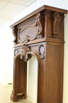 an ornate wooden fireplace surround in a room