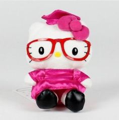 a hello kitty stuffed animal with red glasses and a pink dress sitting on a white surface