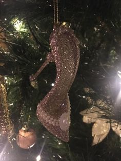 an ornament hanging from a christmas tree in the shape of a female figure