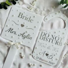 two personalized wedding signs on top of a white blanket