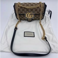 Gucci Gg Marmont Mini Shoulder Bag Black & Brown Gucci Ladies Shoulder Bag. Sku: 446744 Hvkeg 9772. Color: Black. Gucci Gg Marmont Mini Bag. Brown And Black Gg Marmont Shoulder Bag From Gucci Is Constructed From The Brand’s Signature Gg Supreme Canvas And Leather. It Is Enhanced By An Embroidered Pattern And A Logo. The Sliding Chain Strap Smoothly Transforms From A Single Shoulder Length To A Doubled Top Handle Length For Multiple Ways To Wear The Bag. Featuring Half-Round Chain Handle, Main In Gold Monogram Canvas Shoulder Bag With Chain Strap, Gucci Monogram Canvas Evening Bag, Brown Monogram Canvas Bag With Chain Strap, Designer Gucci Gold Bags, Gucci Gold Monogram Canvas Bag, Gucci Gold Bag With Dust Bag, Black Gucci Monogram Canvas Shoulder Bag, Gucci Marmont Mini Bag, Gg Marmont Mini Bag