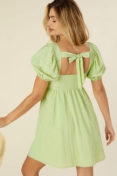 Feel pretty and sweet like spring in our Emilie dress! A beautiful pastel green mini dress featuring cut out detailing and a tie closure. Dress has a square neckline and flattering puff sleeves. Gorgeous cotton lightweight fabric. Lined and not sheer. Perfect for a fun picnic, winery trip or your next vacation! Complete the look with white heels or sandals for an easy, casual look. Pastel Green Square Neckline Puff Sleeves Lined Mini Length Model is 5' 7" and wearing size small. Recommended Sizi Casual Glam, Tie Back Dress, Dress With Puff Sleeves, Top Skirt Set, Green Tie, No See, Womens Tie, Puffed Sleeves Dress, Back Dress