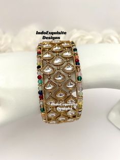 Multi color Kundan Kade/ Bracelet (Single Pc)/Indian bangles/Punjabi bangles Set/Bridal bangles/wedding jewelry/Indian Wedding jewelry/Kundan Polki bridal bangles All items are shipped from Brampton, Ontario, Canada. If you need your item by a certain day, please reach out to us for express delivery option. We kindly request to consider minor variations in colors, shades, textures as pictures displayed may slightly vary from the actual product due to digital image limitations. Please expect the possibility of some minor imperfections when buying handmade jewelry. Please contact us for any questions you might have. Thank you and Happy shopping 😊 Fusion Style Bracelet For Wedding And Diwali, Fusion Style Wedding Bracelet For Diwali, Fusion Style Bangle For Wedding And Diwali, Fusion Style Cutdana Bracelets For Wedding, Fusion Style Wedding Bracelets With Cutdana, Fusion Style Cuff Bangle Bracelet For Festivals, Multicolor Round Beads Bracelets For Weddings, Traditional Stackable Bangle Cuff Bracelet, Multicolor Cutdana Bangle Bracelets