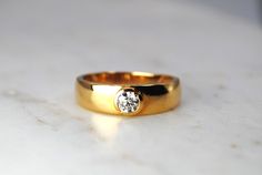 a gold ring with a diamond on it